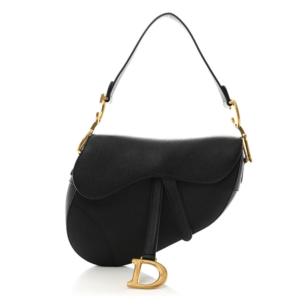 3/4 front view with strap — Dior Saddle Bag Medium in black grained calfskin with antique gold-tone D stirrup and adjustable shoulder strap