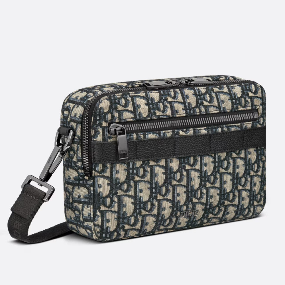 3/4 side view — Dior Men's Safari Messenger Bag in beige and navy blue Dior Oblique jacquard with front zip pockets, silver-tone hardware and adjustable woven 'CHRISTIAN DIOR' shoulder strap